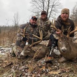 American Comrades co-founders with friend holding deer