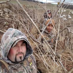 American Comrades co-founders hunting in vegetation